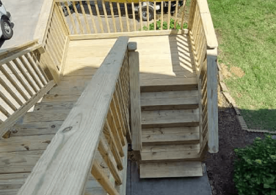 Custom outdoor wooden landing and steps built by Bystone in Birmingham, AL.