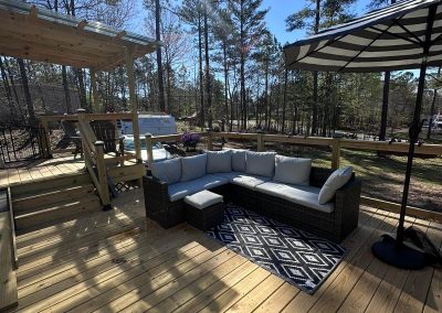 Large multi level wood deck with an attached custom pergola built by Bystone in Birmingham, AL.