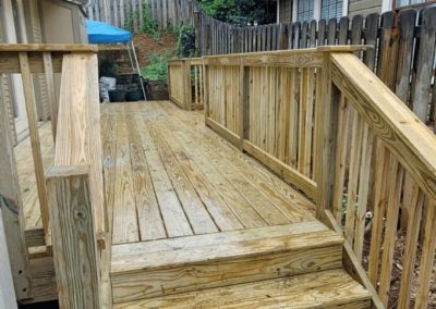 Custom wooden wheelchair access ramp with handrails built by Bystone in Birmingham, AL.