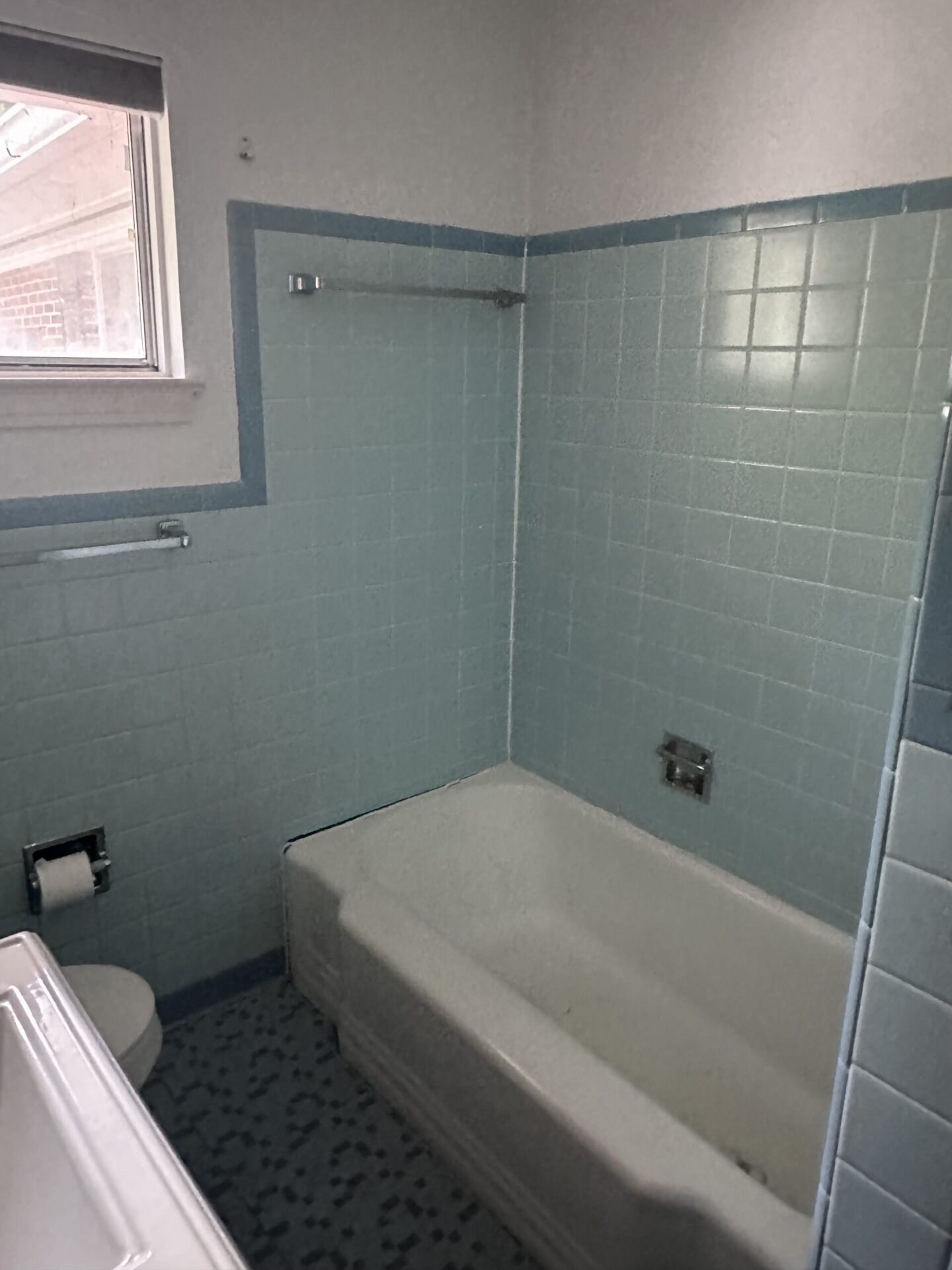 Before photo of an old Bathroom by Bystone in Hoover AL, featuring a typical structural layout, with green subway tile, typical mesh and mortar setting, and old outdated pedestal sink and cast iron tub.