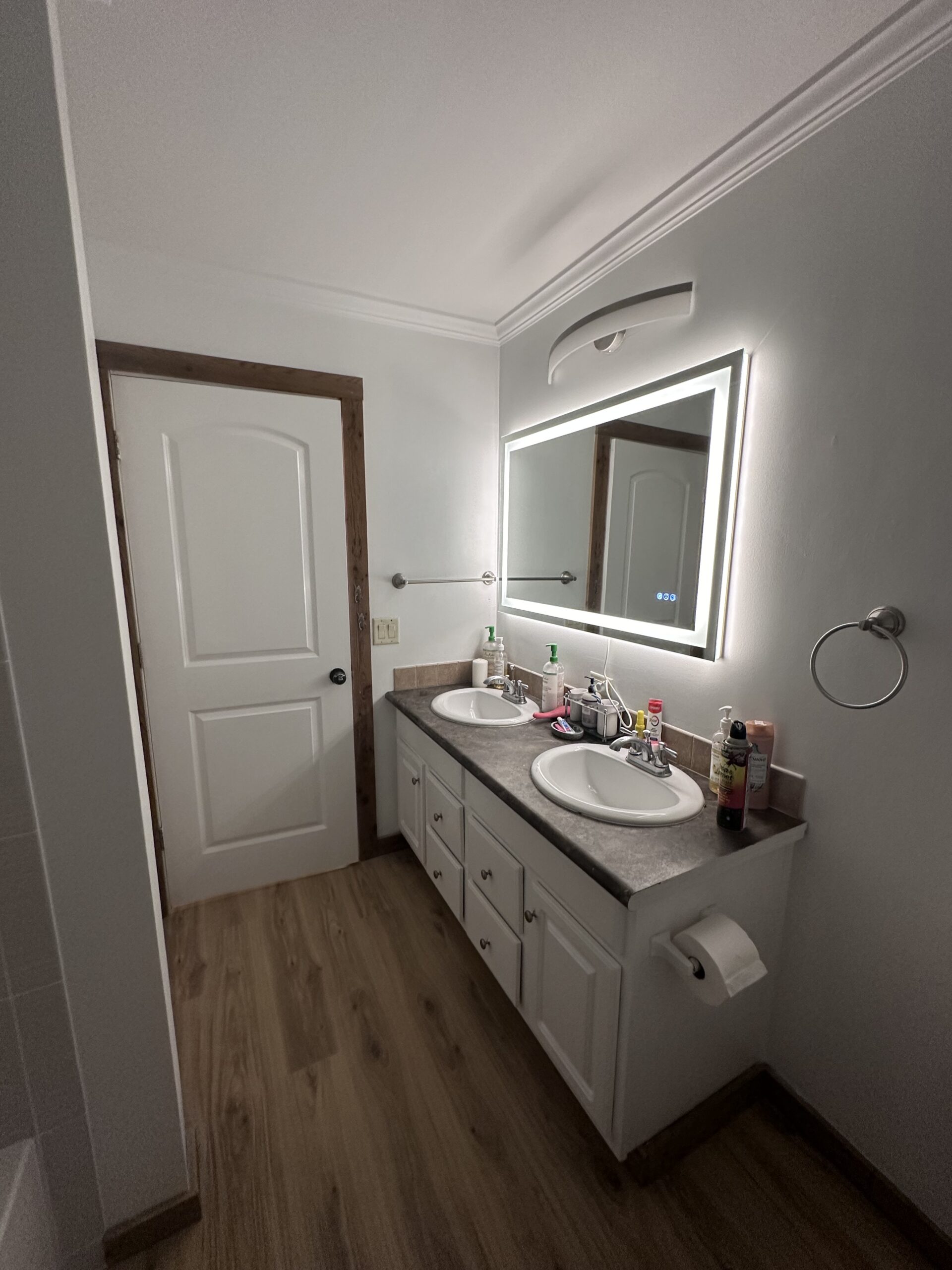 Double Vanity Bathroom Remodel Birmingham AL Modern white double vanity with LED mirror in a completed bathroom remodel in Birmingham Alabama by Bystone