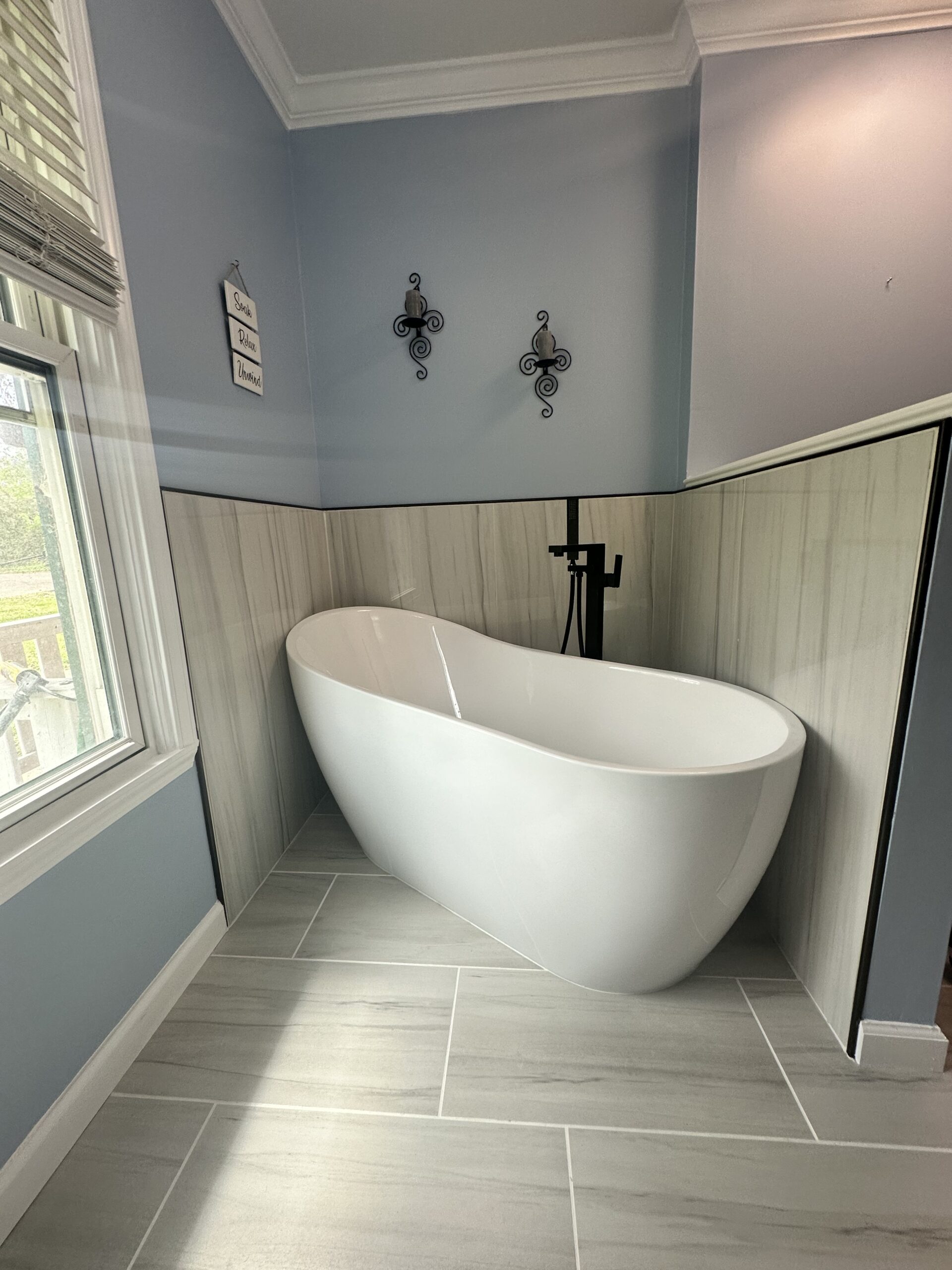 Freestanding Soaking Tub Remodel Birmingham AL Freestanding soaking tub installed in a bright, elegant bathroom remodel by Bystone in Birmingham, Alabama.