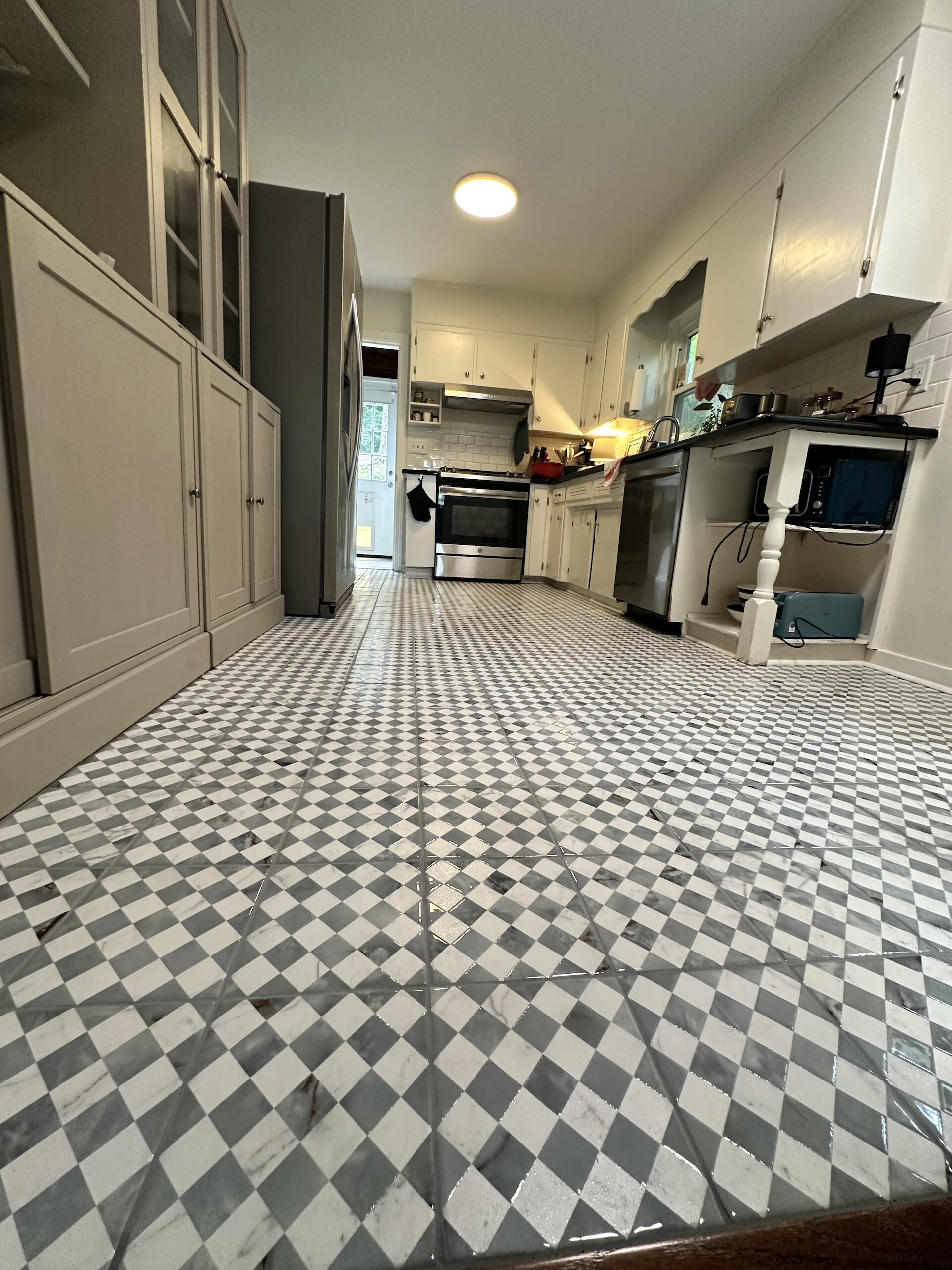 Custom blue and white checkers ceramic tile floor installation by Bystone in Birmingham, AL.