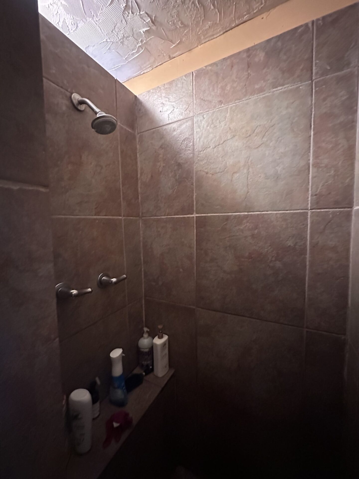 Before photo of an old Bathroom by Bystone in Avondale AL, featuring a bad design and layout, with dark tile